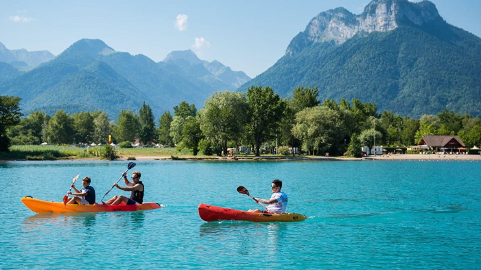 Three People Kayaking on Lake Annecy 