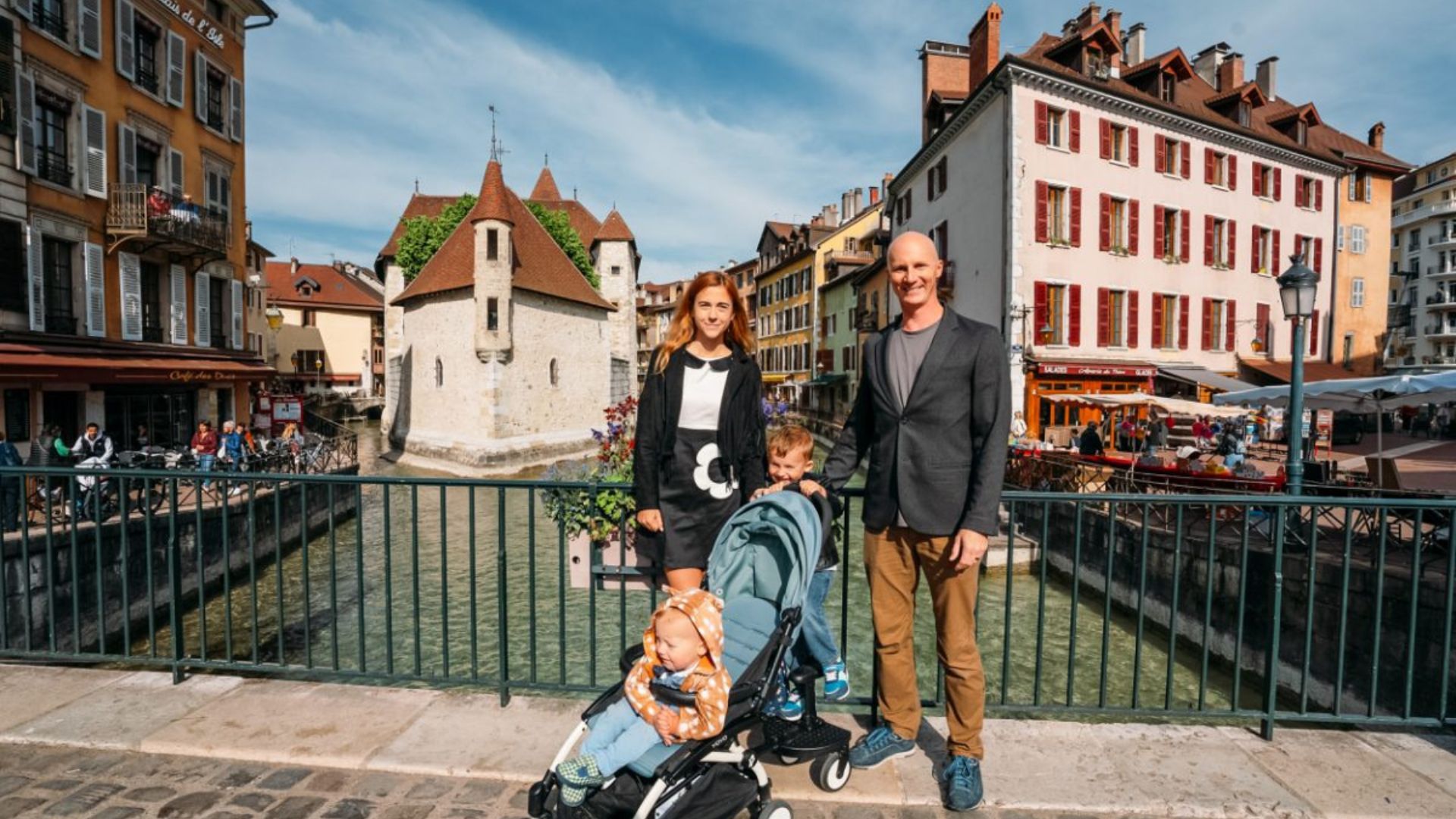 A Family Standing over a Bridge in Carrefour City Annecy